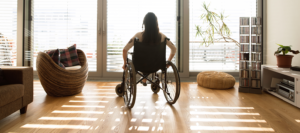 View of a person in a wheelchair looking out their apartment window
