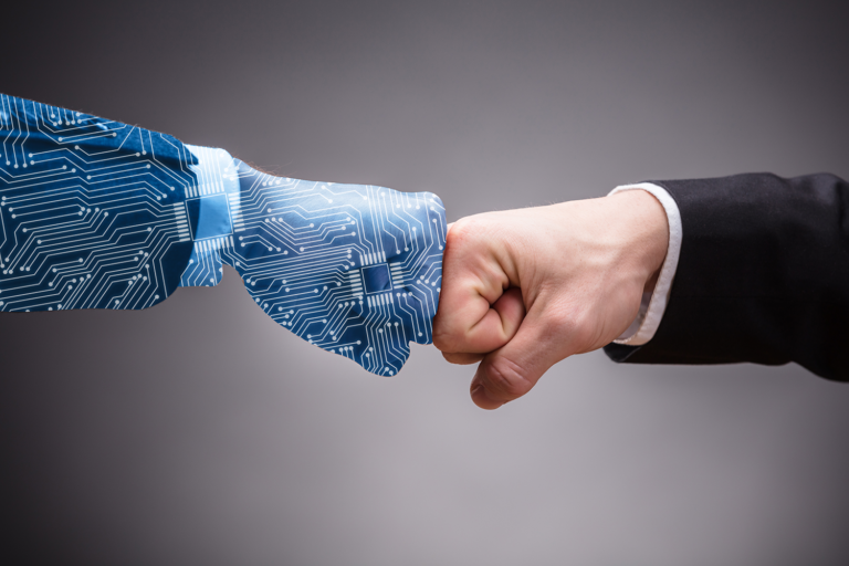A robotic hand fist-bumping a human hand