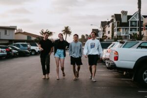 Four friends walking in the parking lot of an apartment community