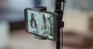 An iPhone on a tripod recording two people talking