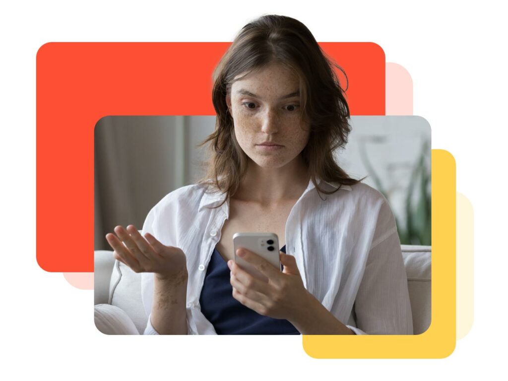 Woman looking frustratingly at her cell phone