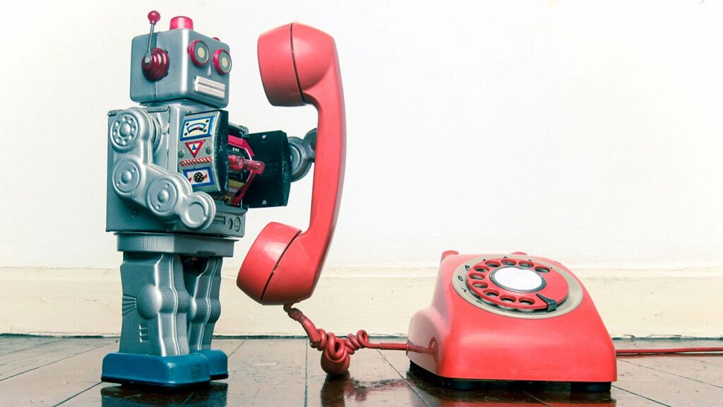 Vintage robot talking on a vintage phone
