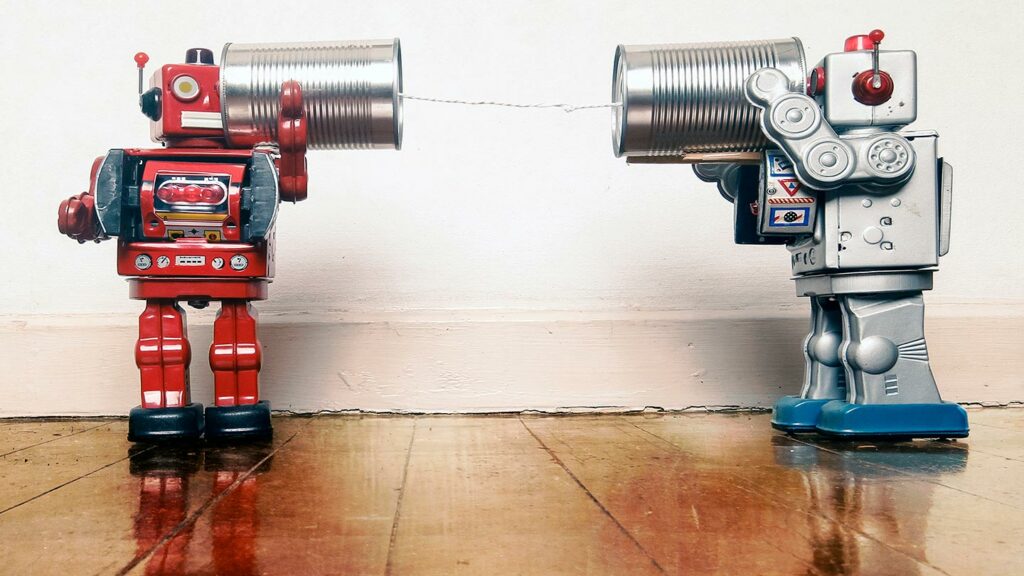 Two vintage robots communicating via cans attached by a string