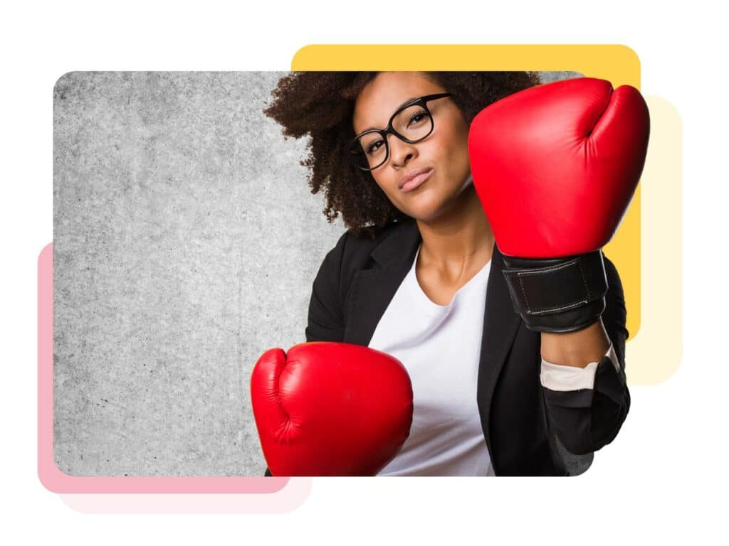 Businesswoman wearing boxing gloves