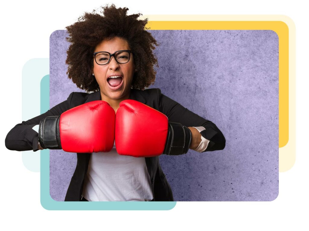 Professional marketing businesswoman shouting as she taps her boxing gloves together