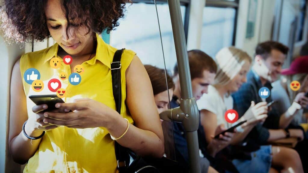 Woman on a train looking at social media on her phone